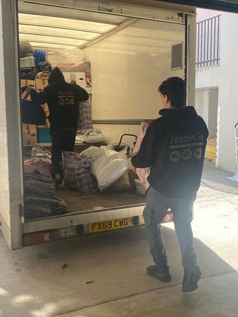 HomeGo removals van professionally packed with strapped and blanket-wrapped office furniture and sealed crates