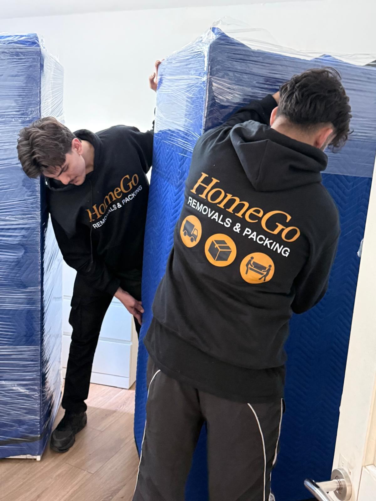 Wrapped and protected items being loaded into HomeGo van