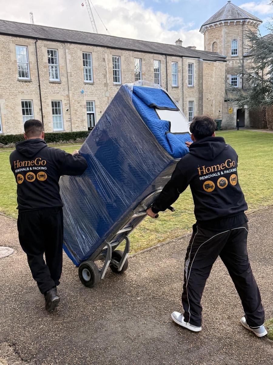 HomeGo crew blanket-wrapping furniture before transit